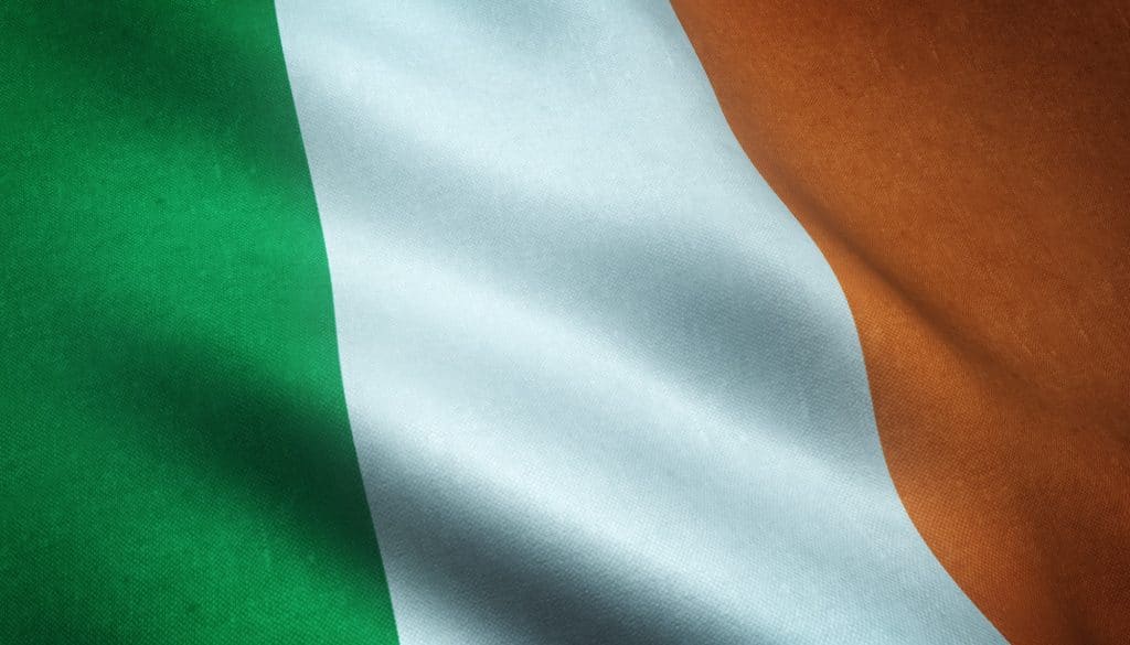 Closeup shot of the waving flag of Ireland with interesting textures